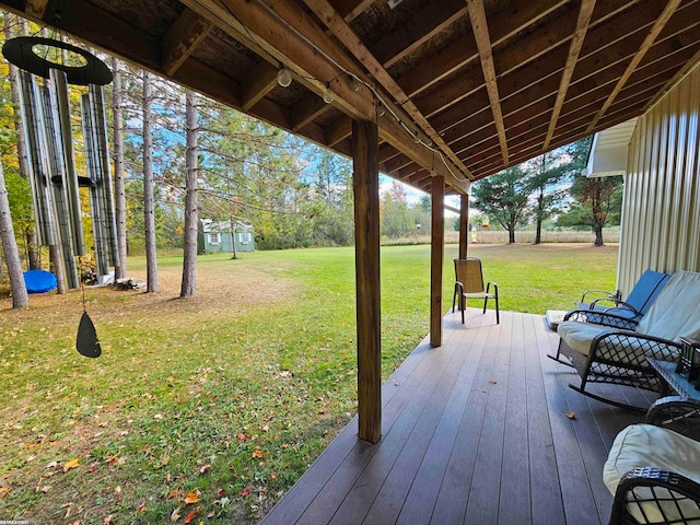 wooden terrace featuring a yard