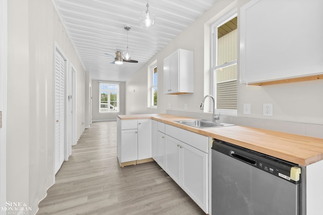 kitchen featuring dishwasher, kitchen peninsula, hanging light fixtures, and white cabinetry