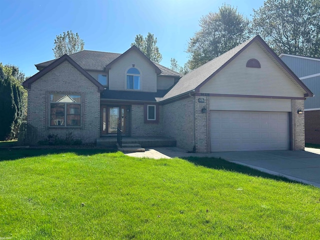 view of front of home with a front yard and a garage