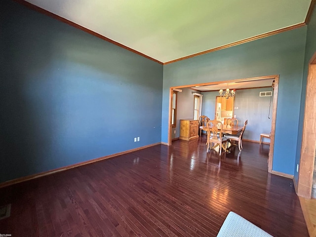 unfurnished dining area featuring ornamental molding, an inviting chandelier, and dark hardwood / wood-style flooring