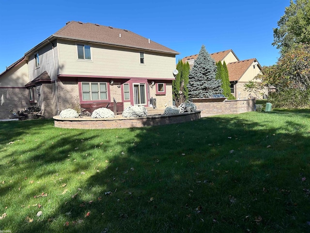 rear view of house featuring a yard