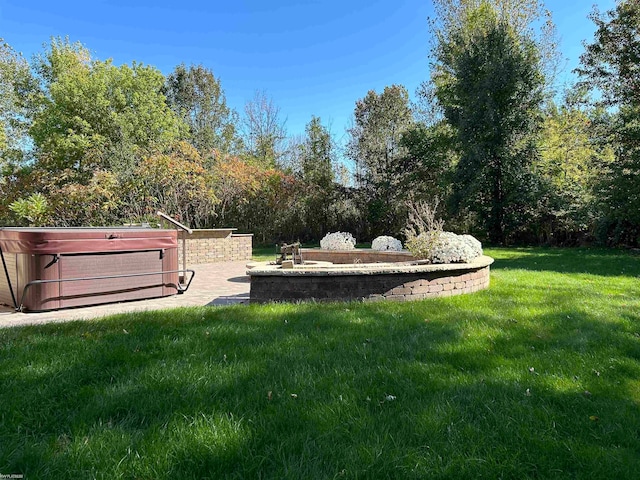 view of yard featuring a patio area and a hot tub