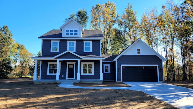 view of front of property featuring covered porch and a garage