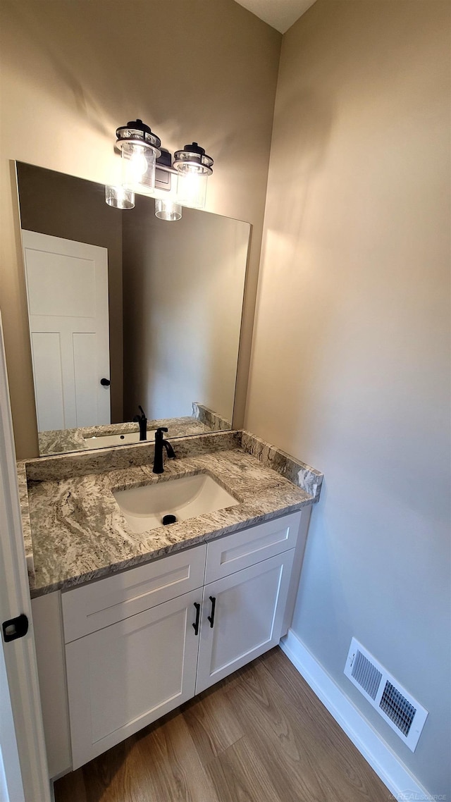 bathroom featuring vanity and hardwood / wood-style floors