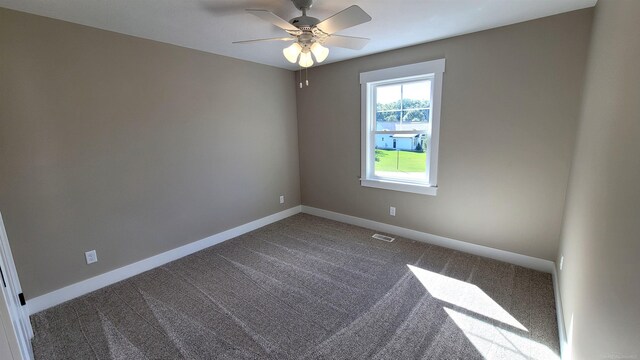 unfurnished room featuring ceiling fan and carpet floors