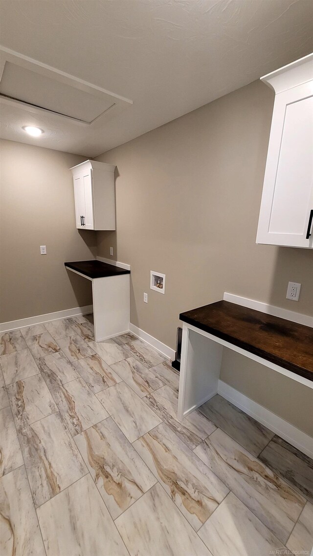 laundry room featuring hookup for a washing machine and cabinets