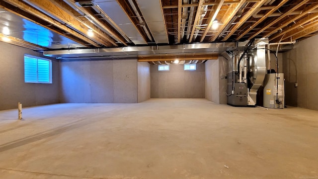 basement featuring gas water heater and heating unit