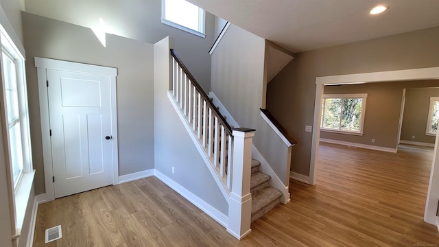 stairs featuring vaulted ceiling and hardwood / wood-style floors