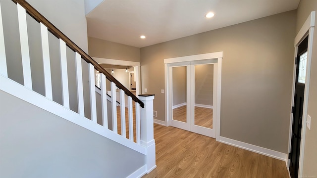 entrance foyer featuring french doors and light hardwood / wood-style flooring