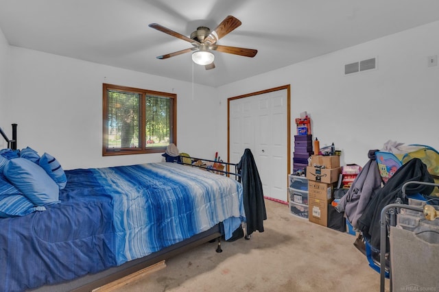 carpeted bedroom featuring a closet and ceiling fan