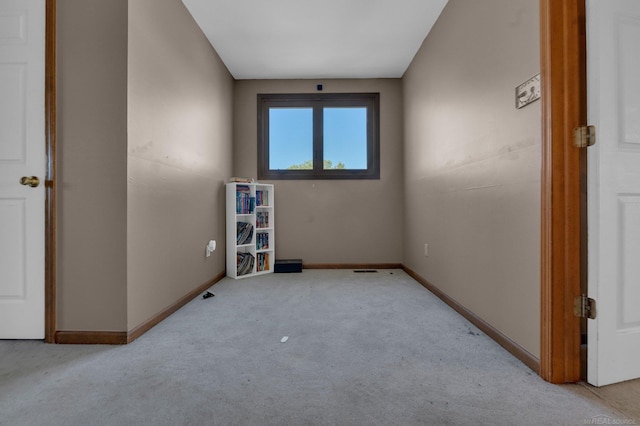 spare room featuring light colored carpet