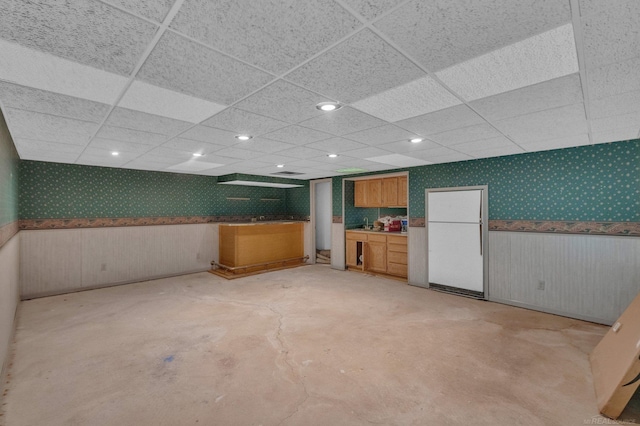 basement with a paneled ceiling