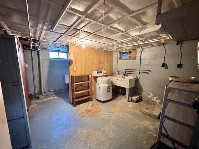 basement with wood walls and sink