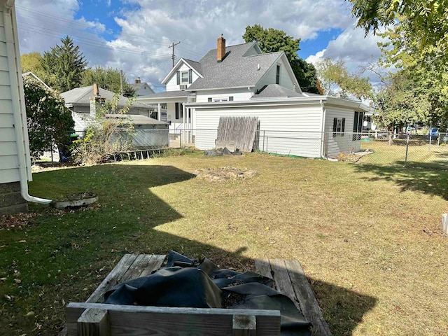 rear view of property featuring a lawn