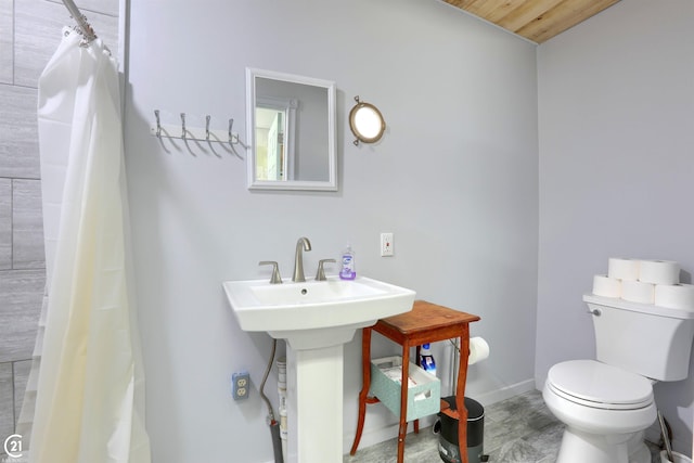 bathroom featuring walk in shower, toilet, and wood ceiling