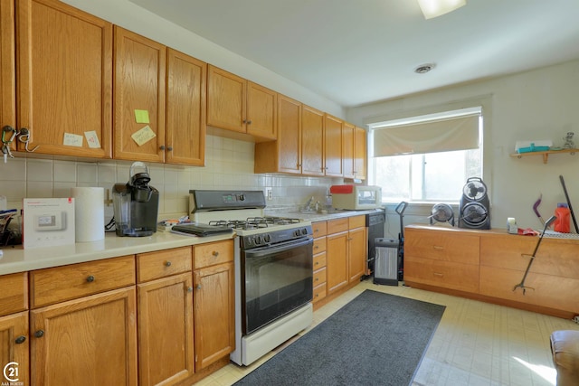 kitchen featuring white appliances, sink, and tasteful backsplash