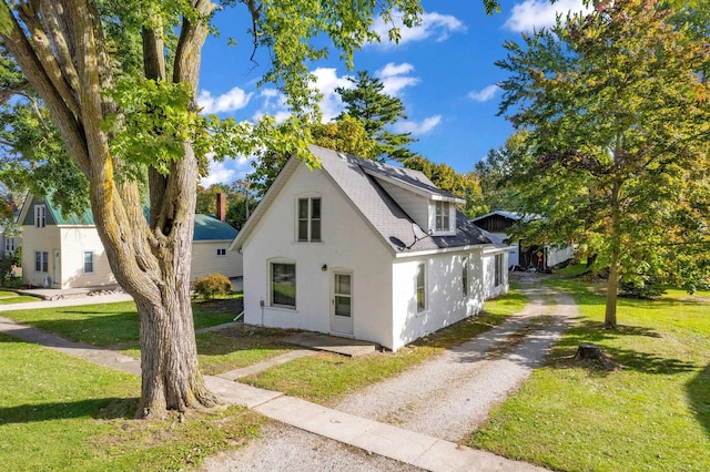 view of side of home featuring a yard