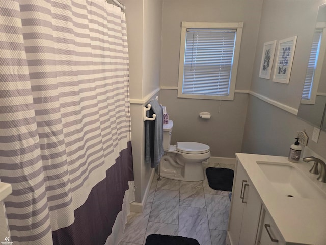 bathroom featuring vanity, toilet, and curtained shower