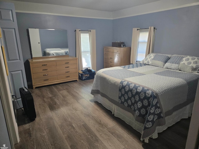 bedroom featuring dark hardwood / wood-style flooring