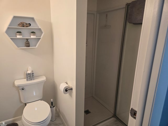 bathroom featuring a shower and toilet