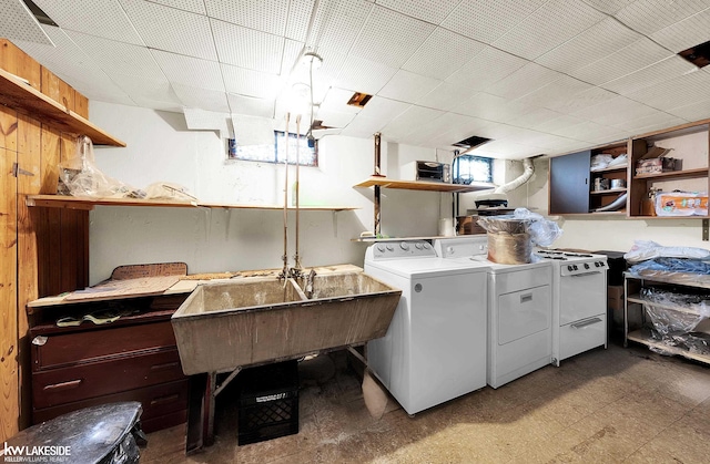 washroom featuring washing machine and clothes dryer and sink