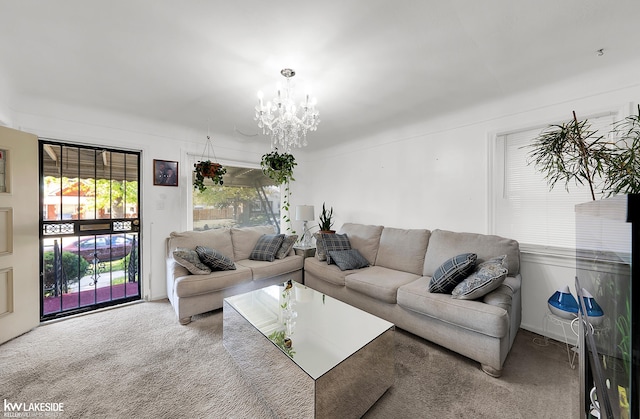 living room with carpet floors and a notable chandelier