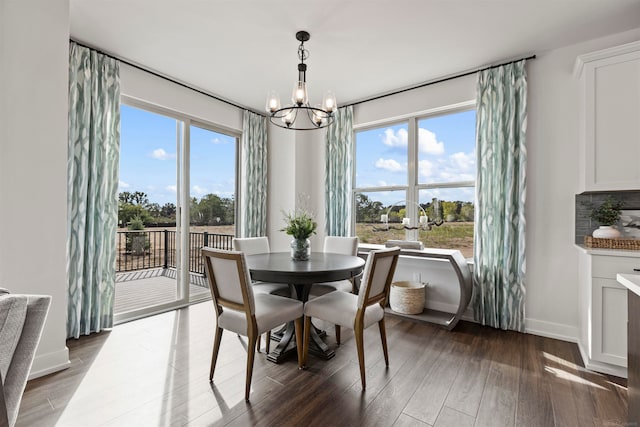 dining room with a notable chandelier, dark wood-type flooring, and a wealth of natural light