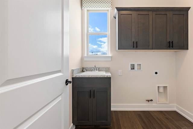 washroom featuring hookup for an electric dryer, sink, dark hardwood / wood-style flooring, washer hookup, and gas dryer hookup