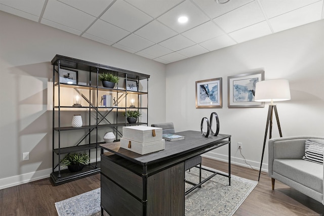 office area with wood-type flooring and a drop ceiling