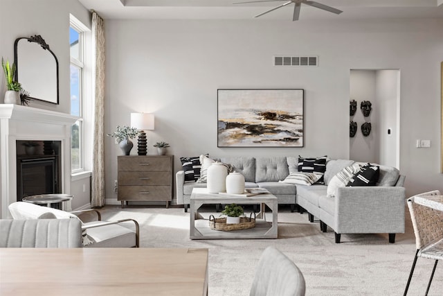 living room with light carpet and ceiling fan