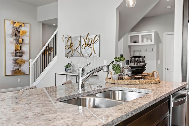 kitchen with light stone countertops and sink