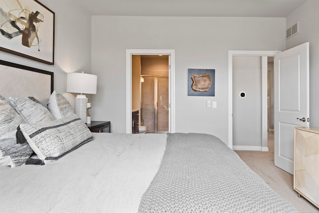 bedroom with connected bathroom and light colored carpet