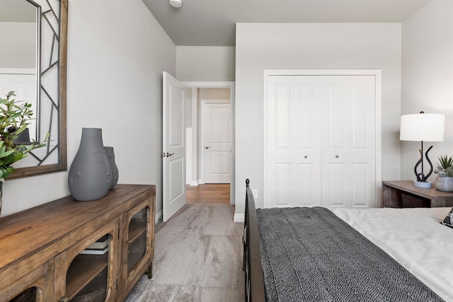 bedroom with light colored carpet and a closet