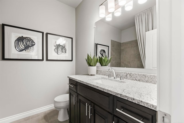 bathroom with vanity, tile patterned flooring, and toilet