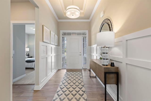 foyer featuring ornamental molding and hardwood / wood-style floors