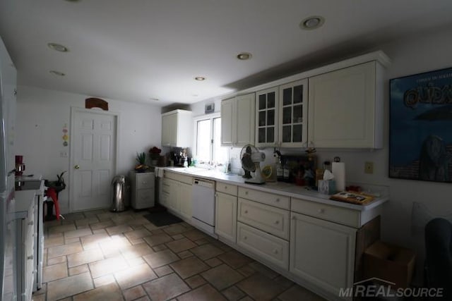 kitchen featuring dishwasher and white cabinetry