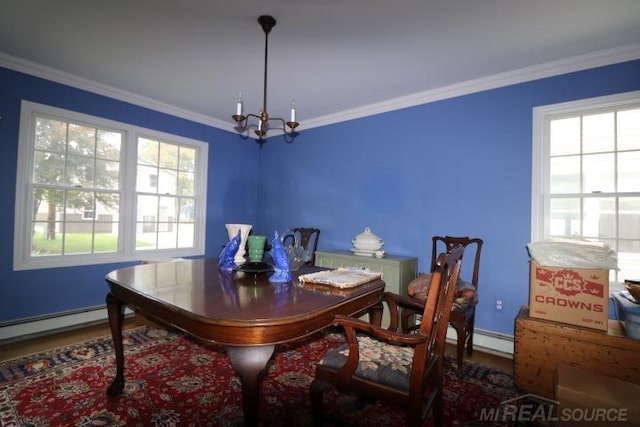 dining room featuring an inviting chandelier, hardwood / wood-style flooring, and crown molding