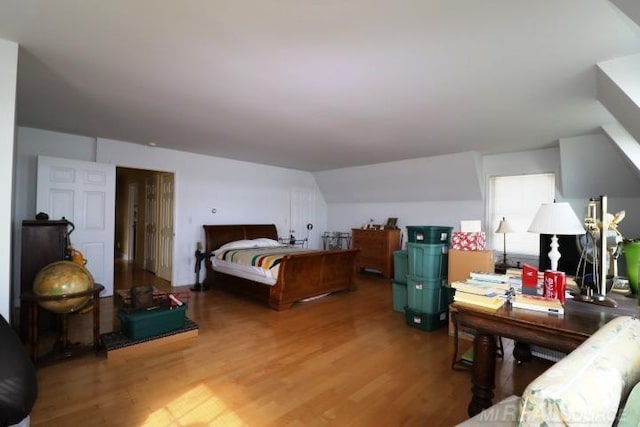 bedroom with lofted ceiling and hardwood / wood-style floors