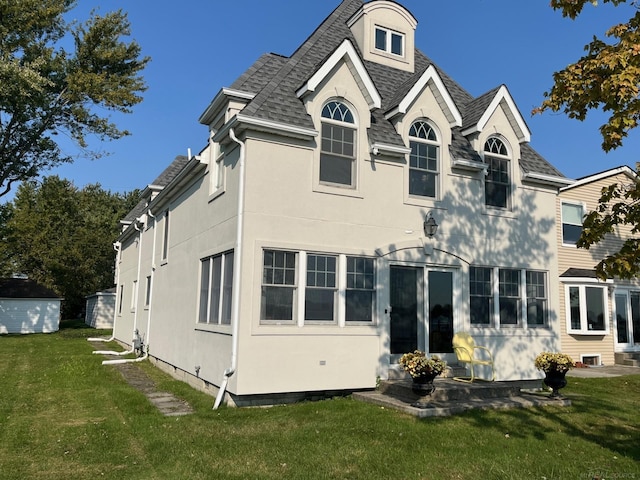 rear view of house with a lawn