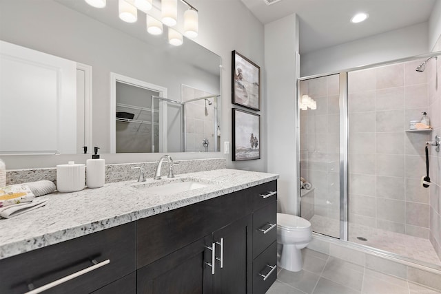 bathroom with walk in shower, vanity, toilet, and tile patterned floors