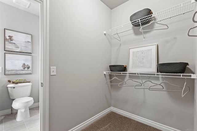 walk in closet with tile patterned flooring