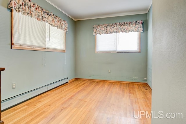 unfurnished room with crown molding, baseboard heating, and hardwood / wood-style flooring