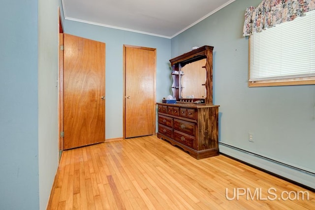 unfurnished bedroom with ornamental molding, light wood-type flooring, and a baseboard radiator