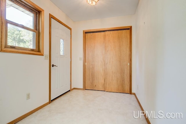 entrance foyer with light colored carpet