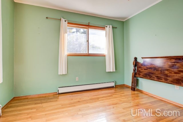 bedroom with light hardwood / wood-style flooring, crown molding, and a baseboard heating unit