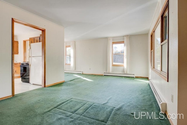 carpeted spare room featuring ornamental molding and a baseboard radiator