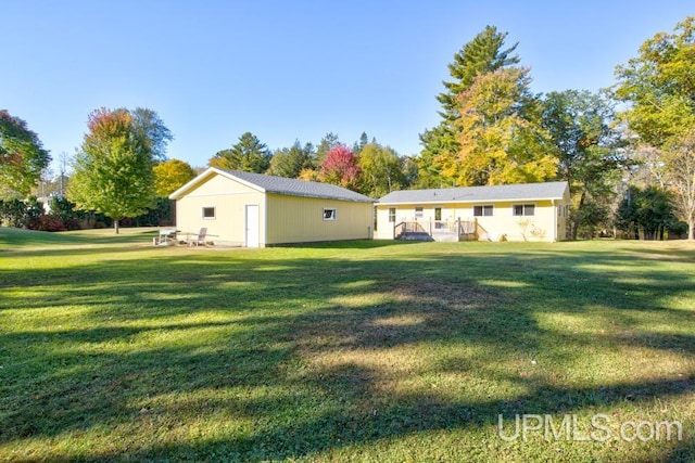 rear view of property featuring a lawn