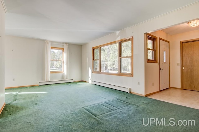 spare room with carpet, ornamental molding, and a baseboard heating unit