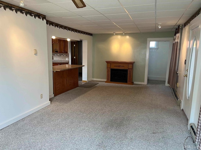 unfurnished living room with a baseboard heating unit