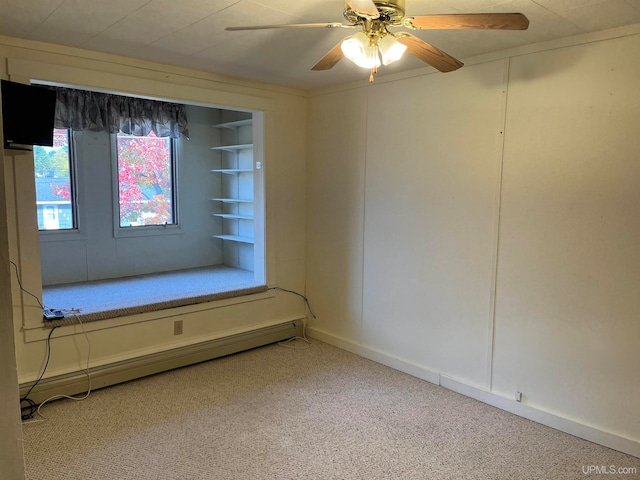 empty room featuring carpet, ceiling fan, and a baseboard radiator